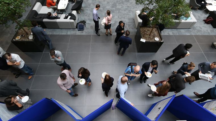 Photo of groups of people having discussions in the atrium of the Big Data Institute.