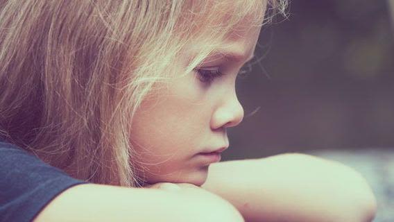 Profile photo of a child looking pensive.
