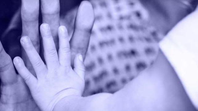 Image of UK Covid-19 Inquiry website homepage with a child and an adult hand touching.